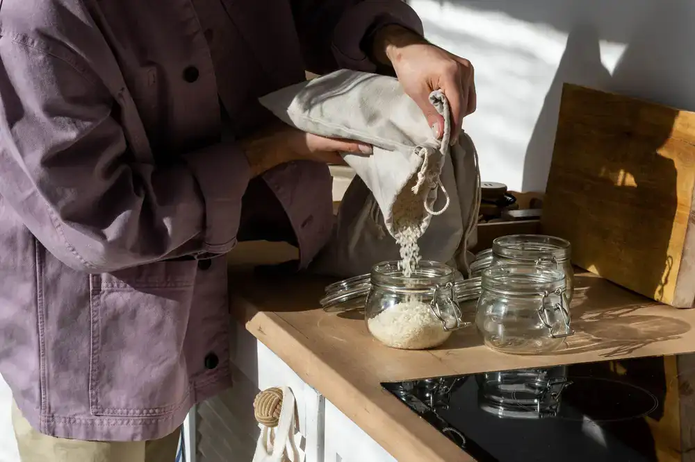Pouring loose grains into a cotton bag