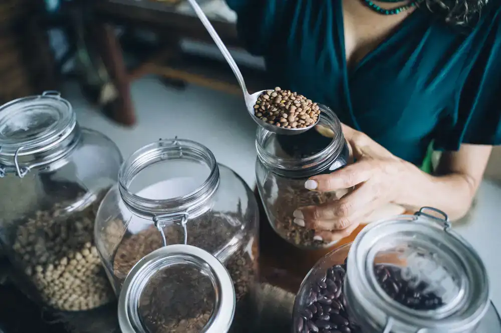 Customer filling a reusable jar with dry lentils