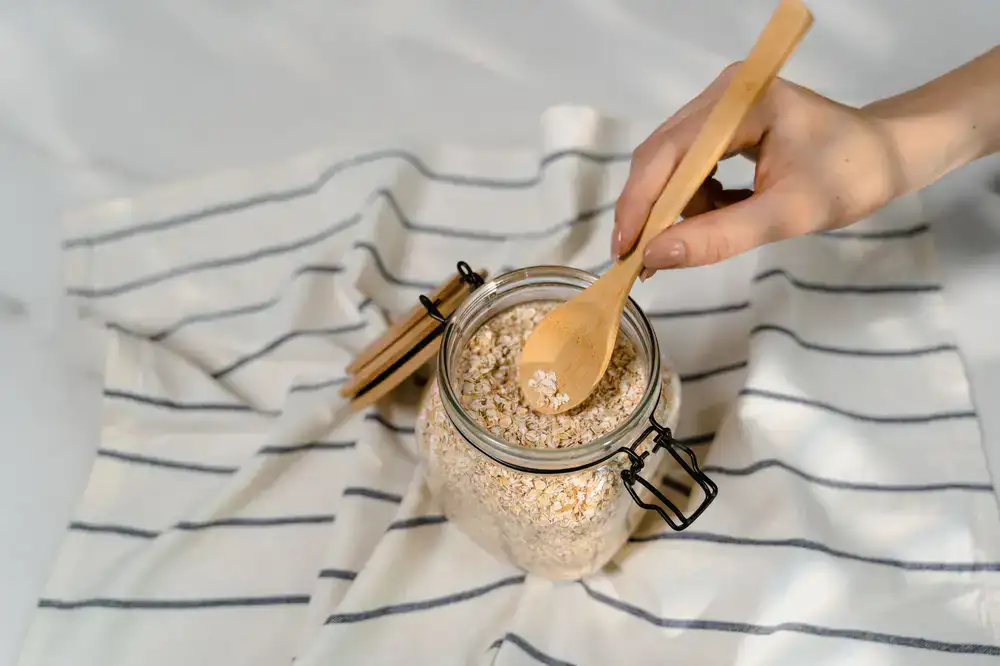 Close up of whole oats being scooped